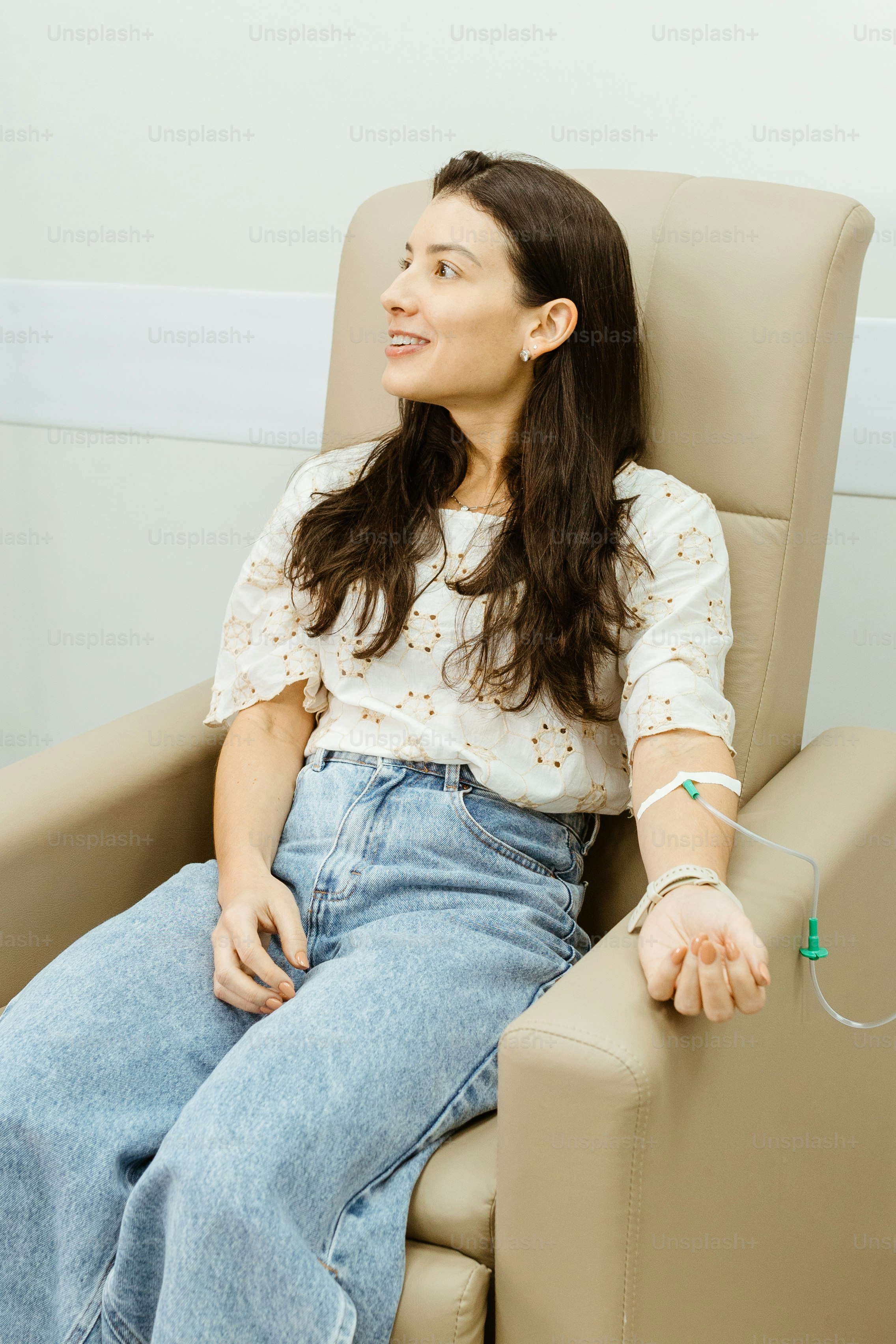 a woman sitting in a chair with her hand on her hip