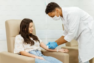 a woman getting her hands examined by a doctor