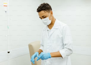 a man in a white lab coat and blue gloves
