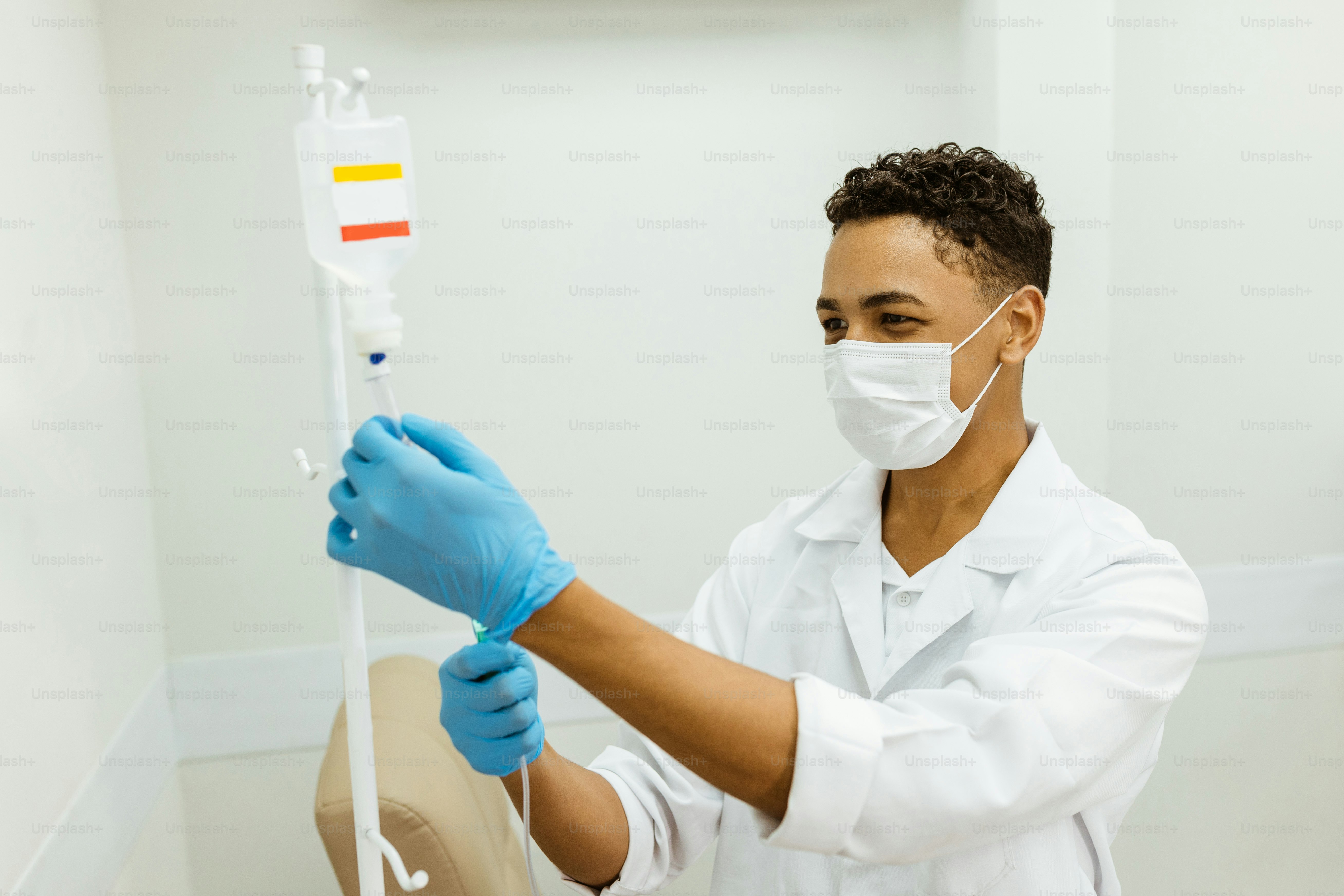 a man in a white lab coat holding a toothbrush