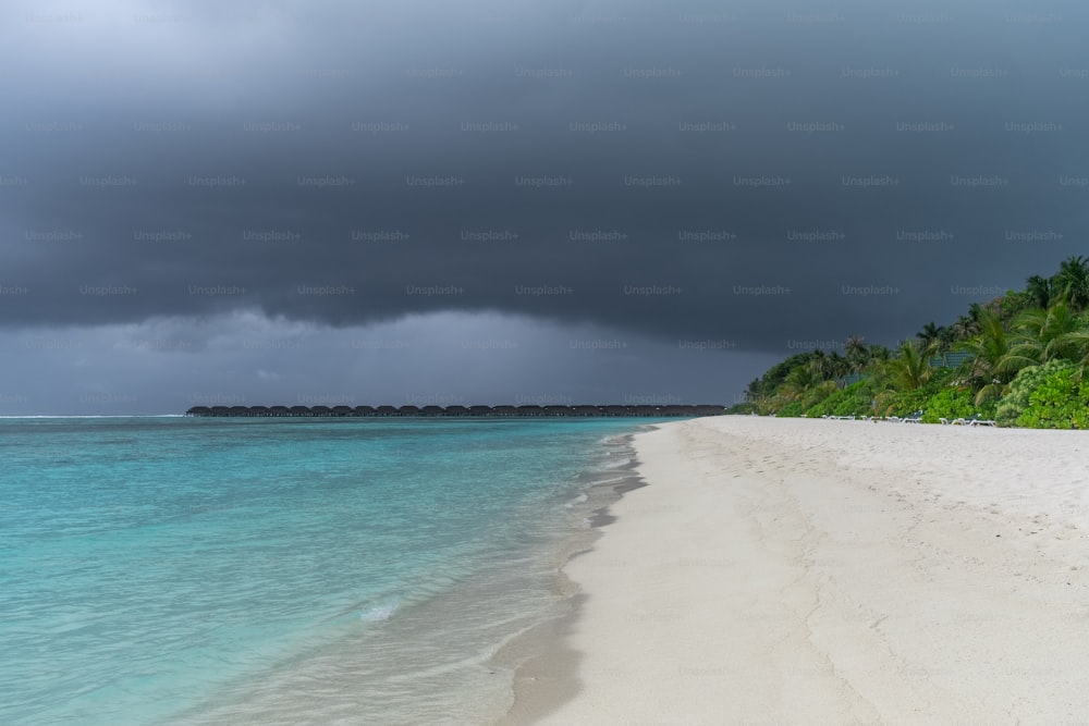 a white sandy beach under a cloudy sky