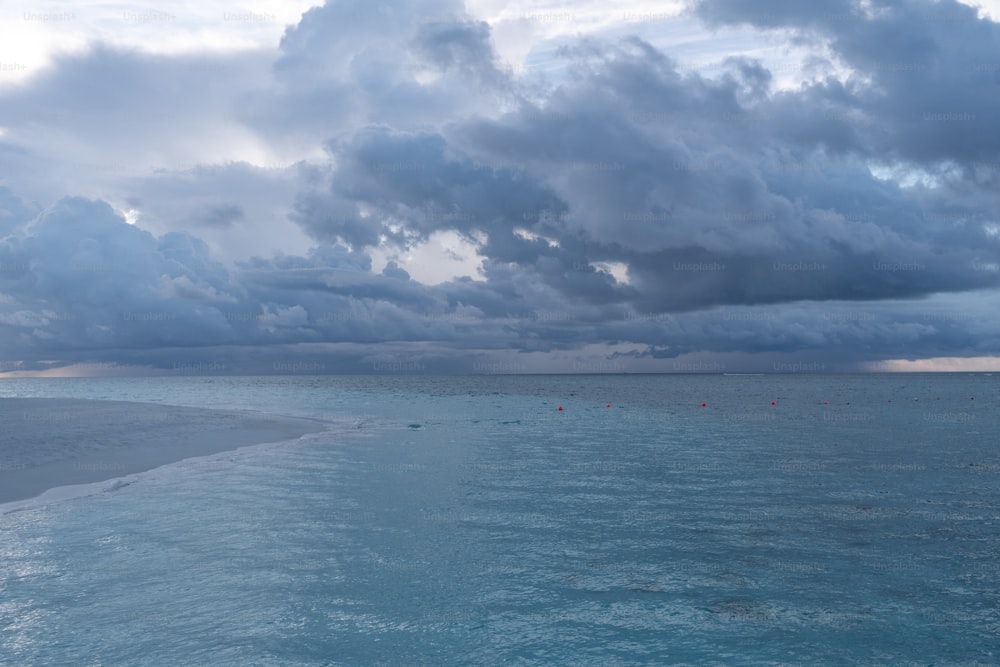 a large body of water under a cloudy sky