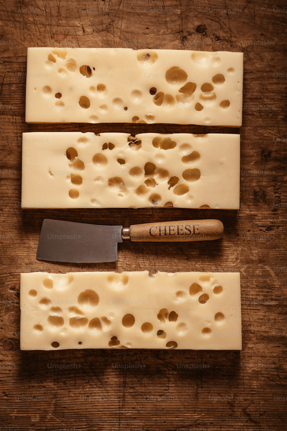 a cheese board with cheese and a knife on it