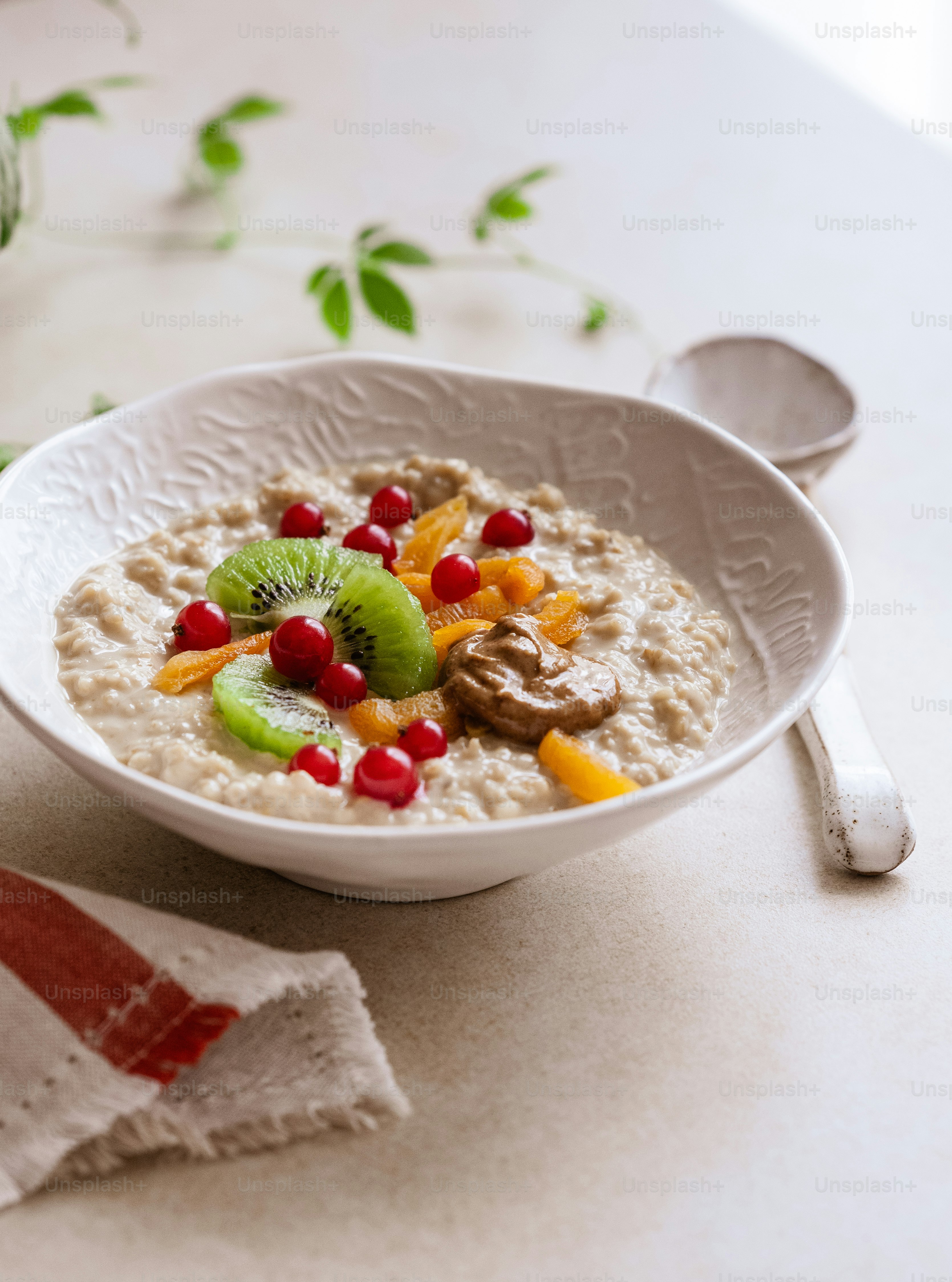 a bowl of oatmeal with fruit and nuts