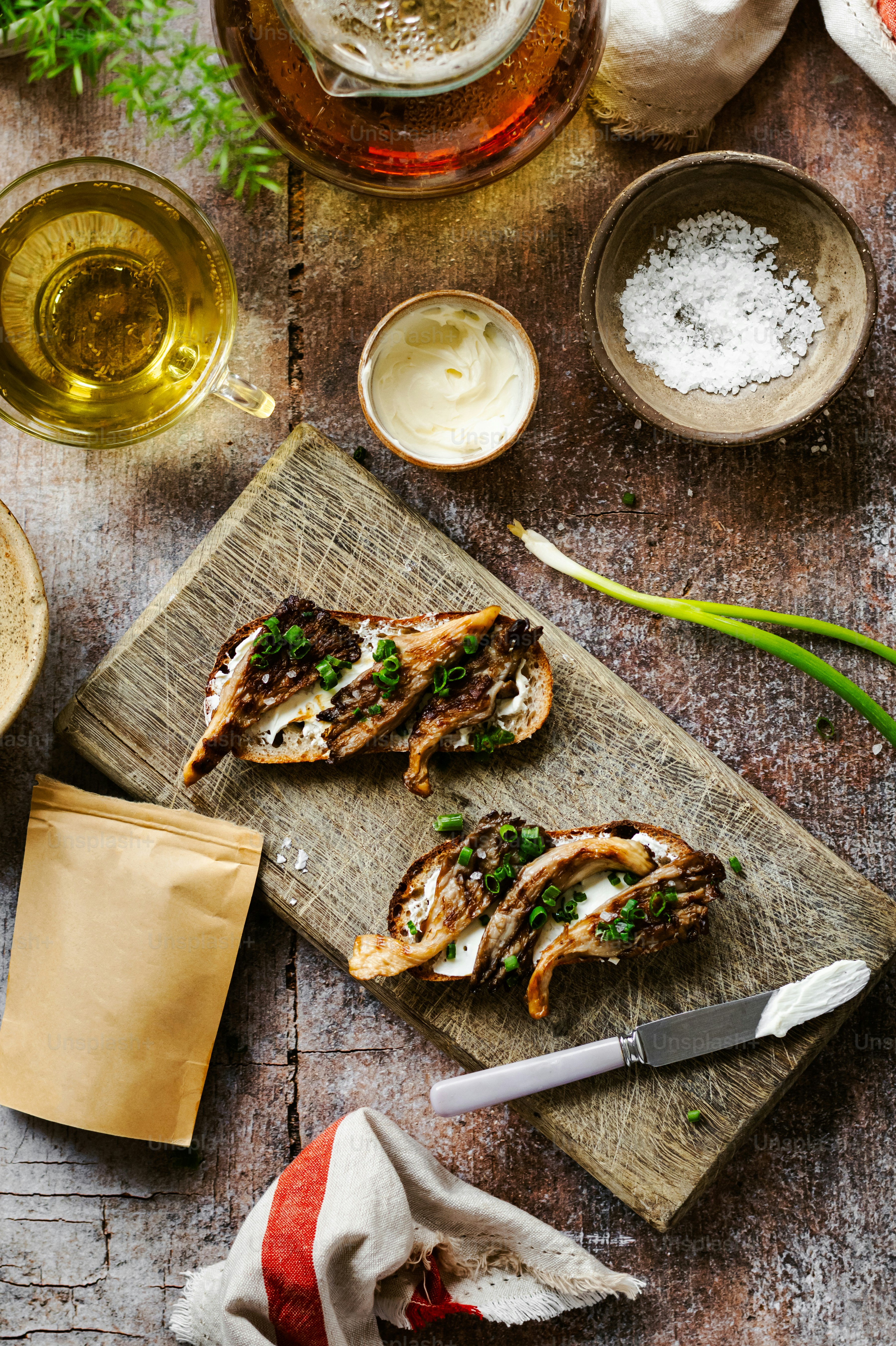 a wooden cutting board topped with meat and veggies