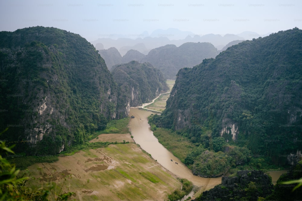 a river running through a valley surrounded by mountains