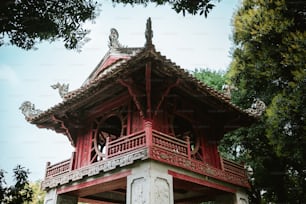 a red and white building with a bird on top of it