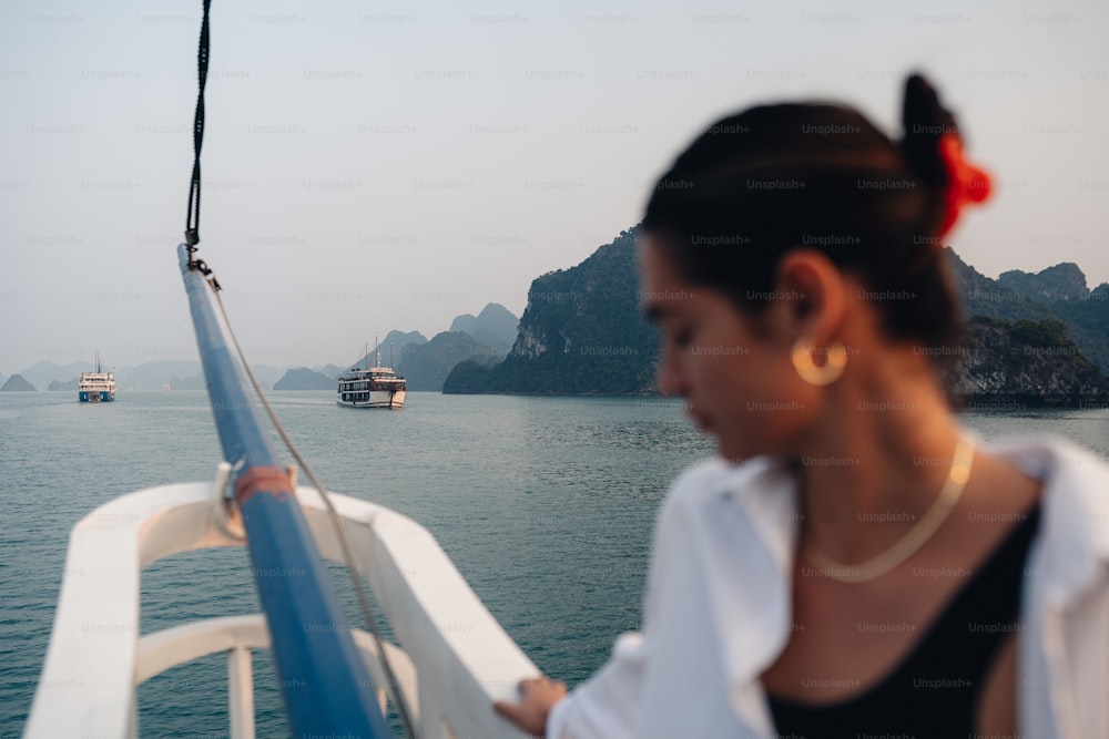 a woman standing on a boat in the water