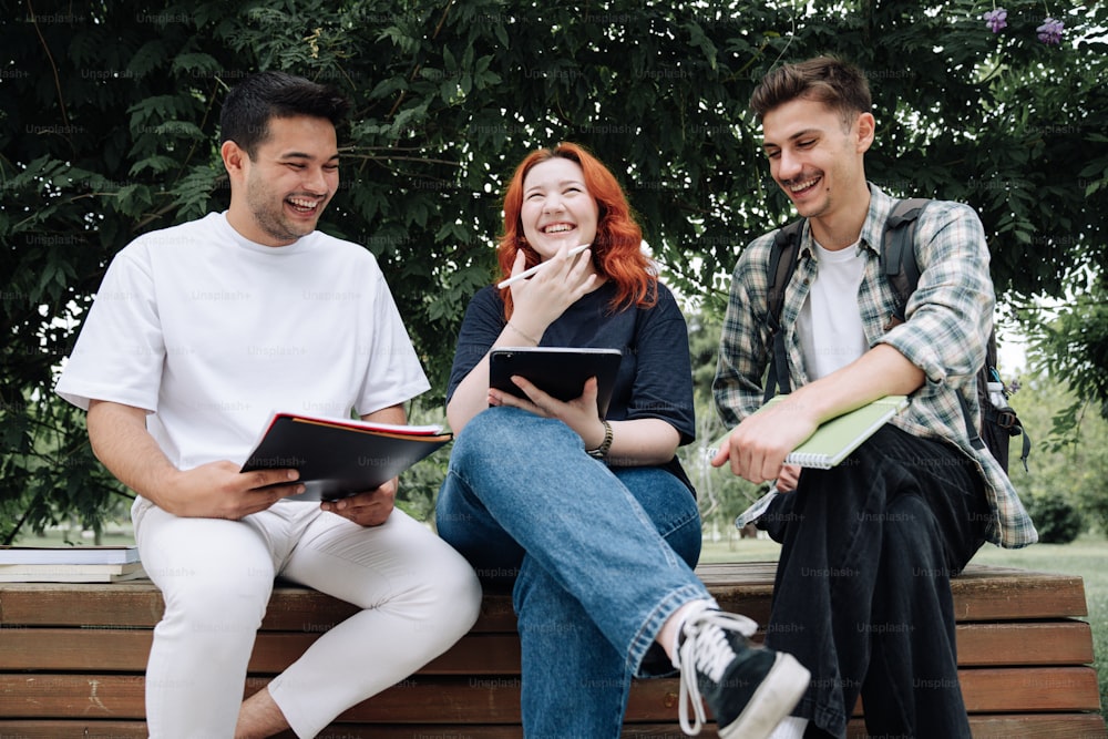 a group of people sitting on a wooden bench