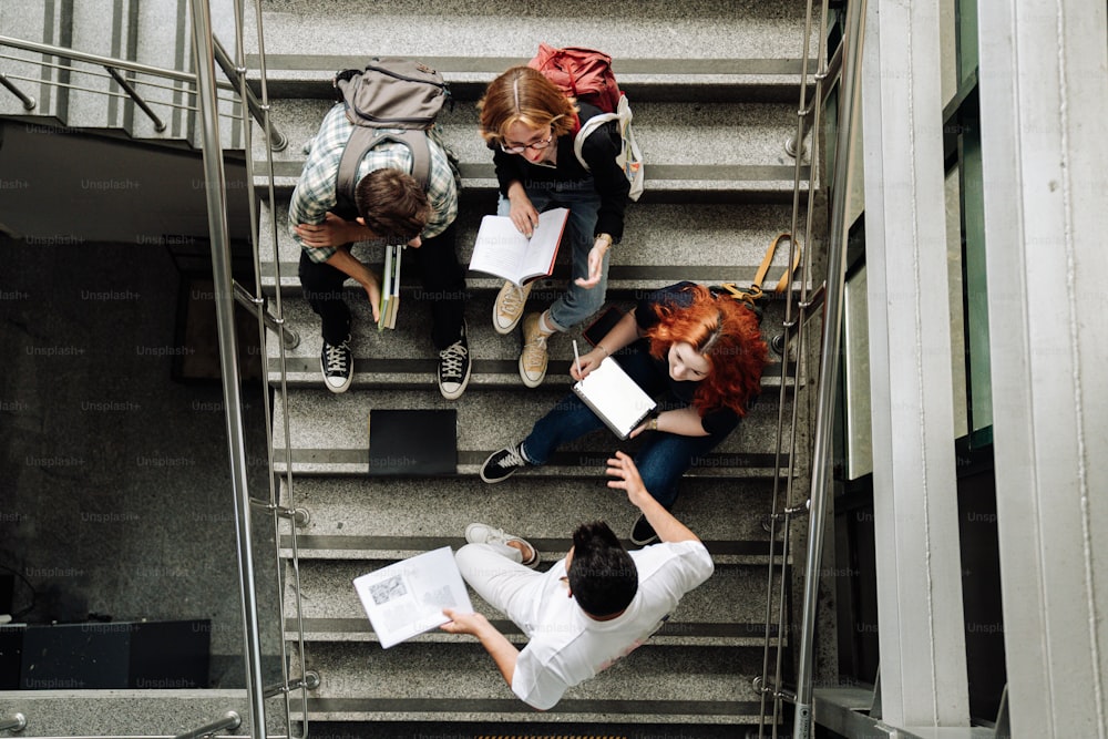 a group of people sitting on top of a set of stairs