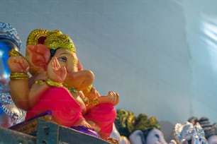 a statue of a ganeshi sitting on a shelf