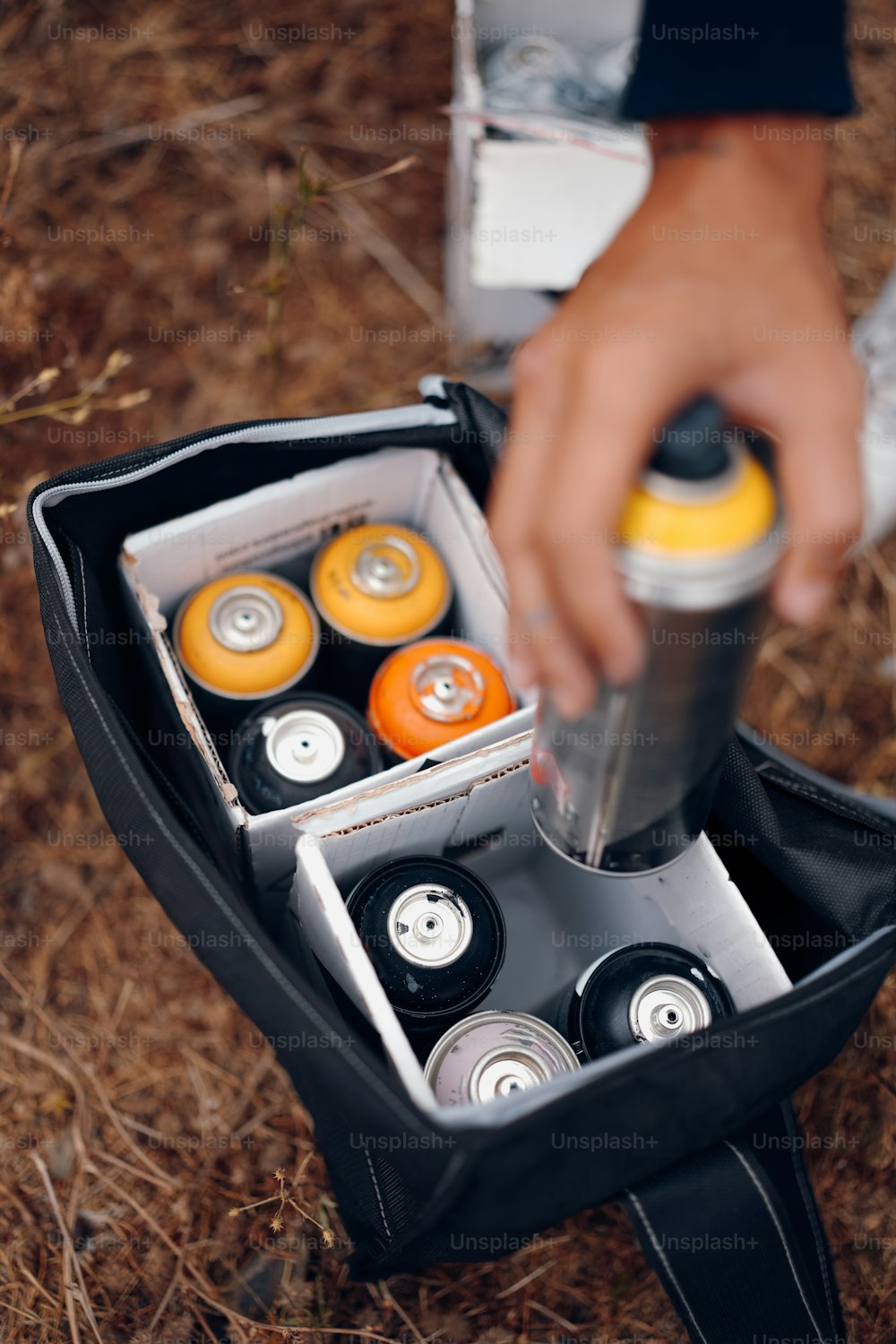 a person holding a can of soda in a case