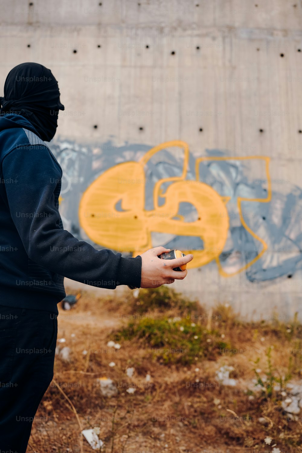 a man in a black hoodie holding a cell phone