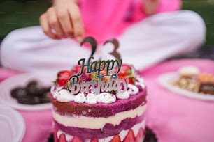 a child is cutting a birthday cake with a knife