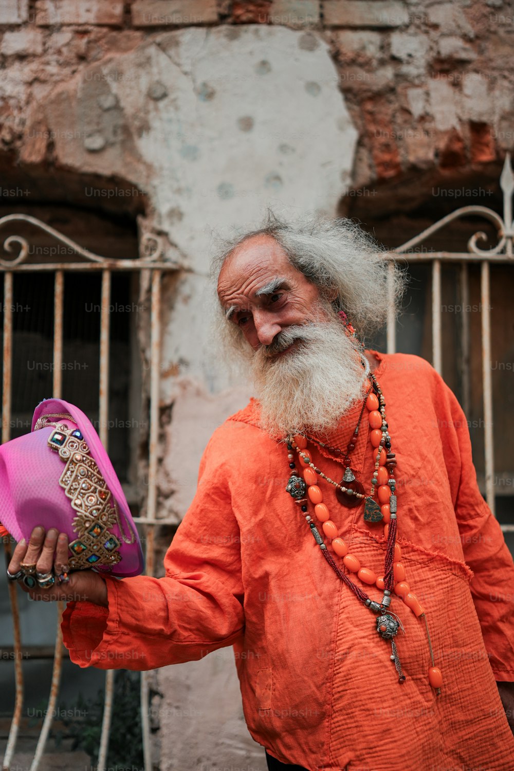 a man with a long white beard holding a pink purse