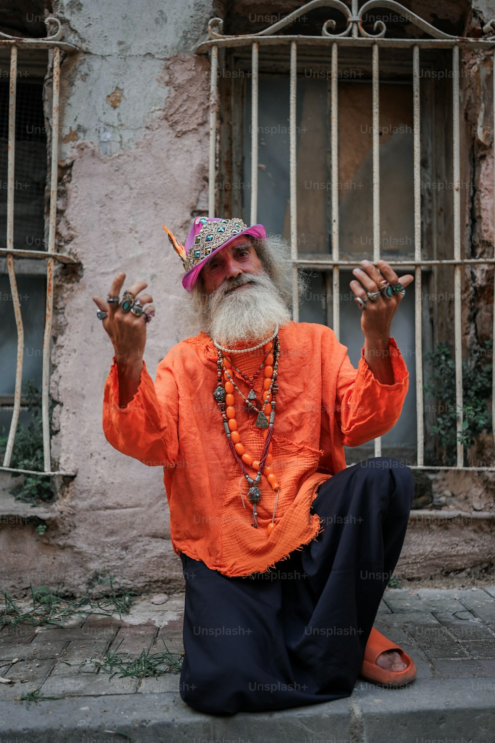 a man with a long white beard sitting on the ground