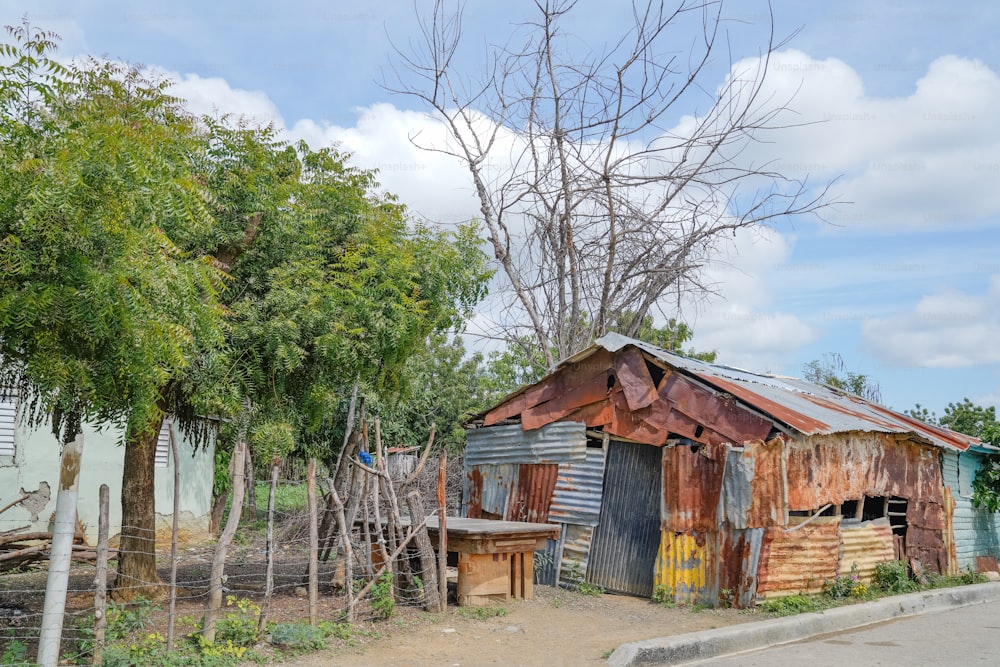 an old shack with a rusty roof and a broken door