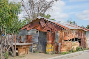 an old shack with a rusty tin roof