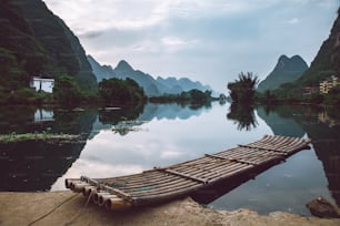 a long wooden raft sitting on top of a river