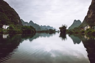 a body of water with mountains in the background