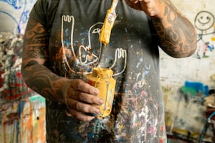 a man holding a paintbrush in his right hand