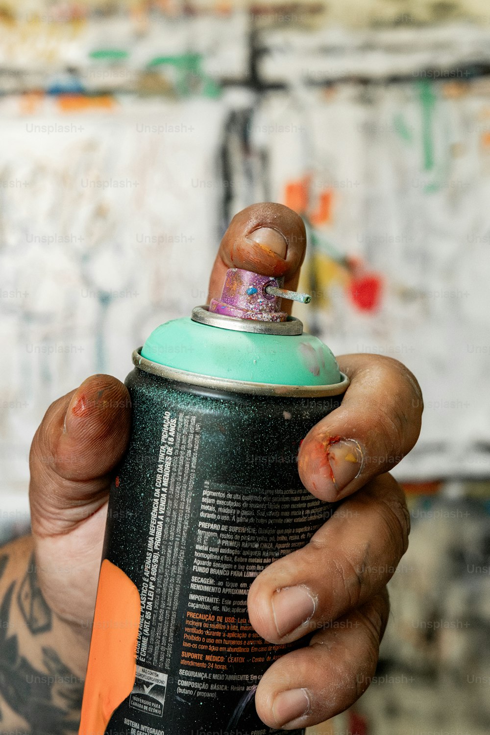 a person holding a can of beer in their hand