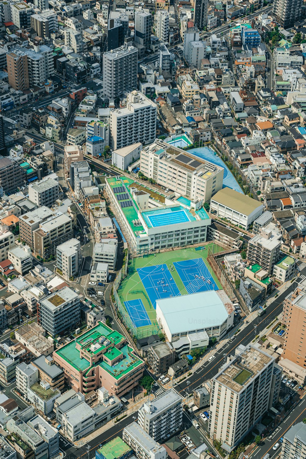 an aerial view of a city with a tennis court