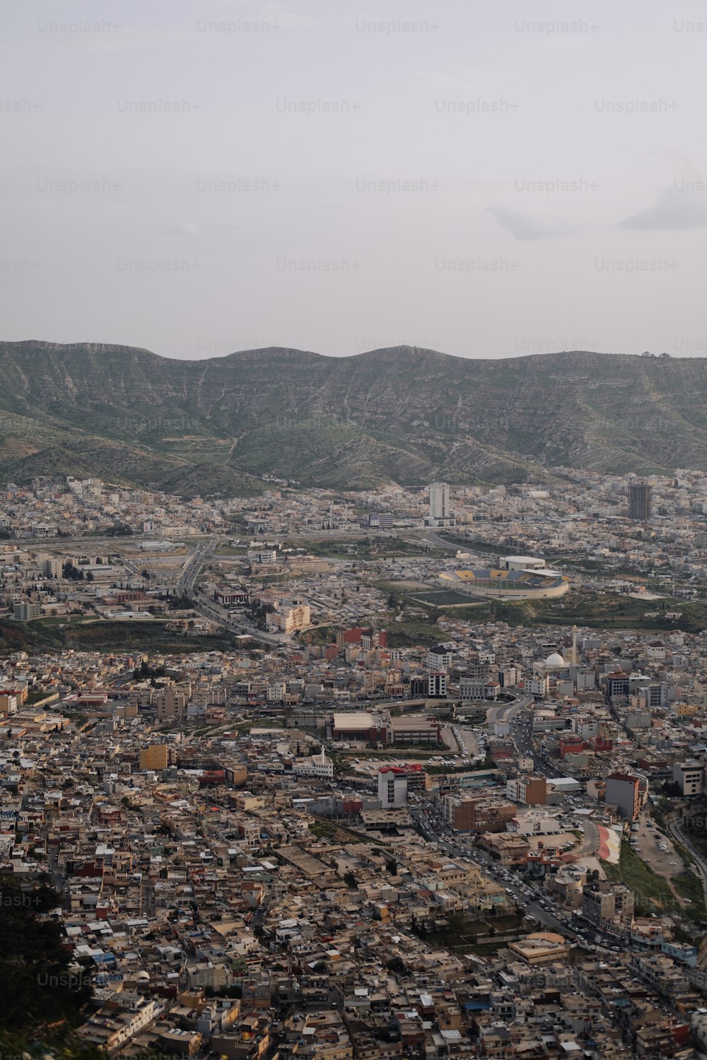 a view of a city with mountains in the background