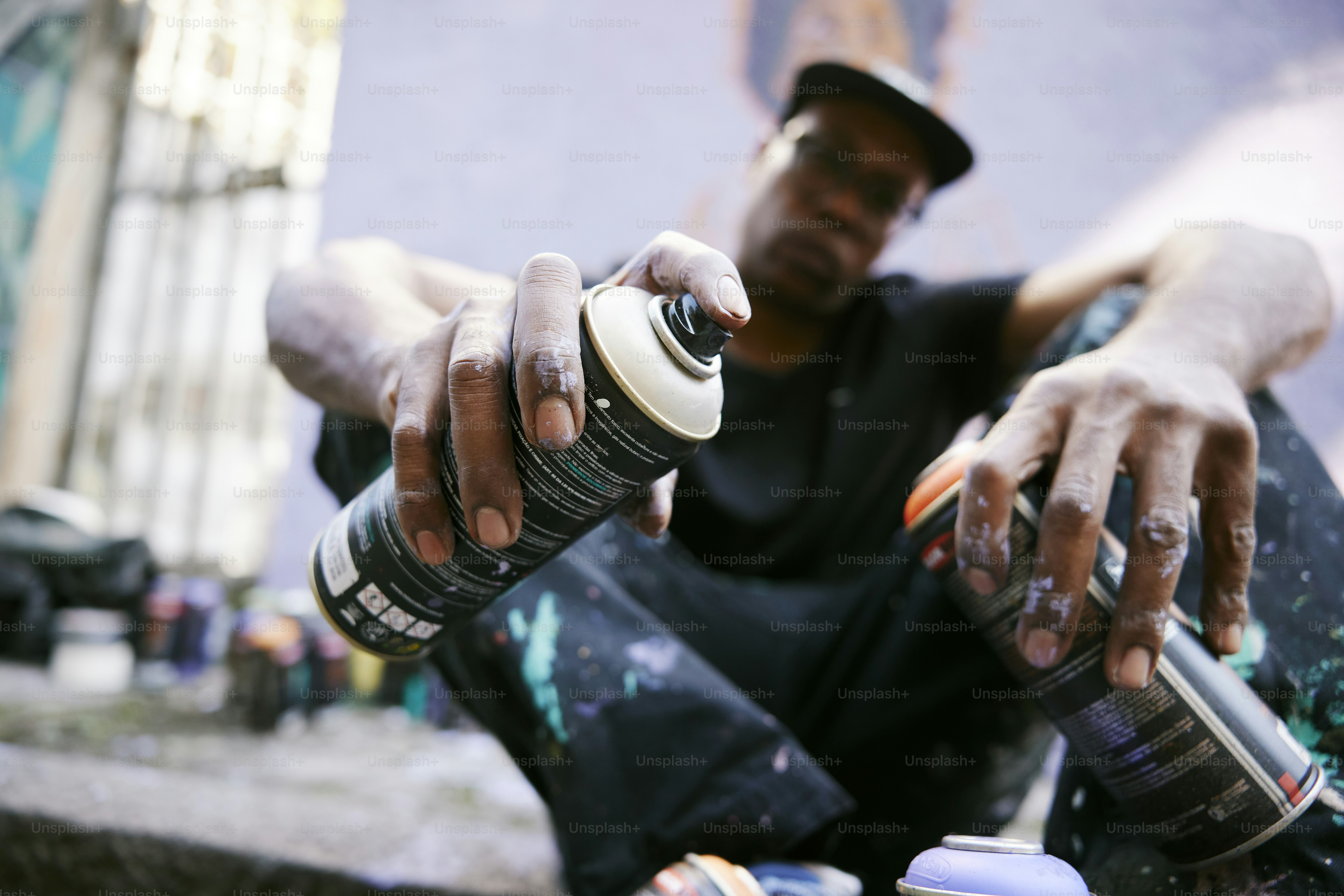 a man sitting on the ground with a skateboard