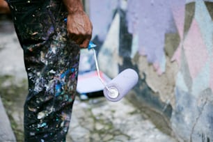 a man is holding a roll of toilet paper