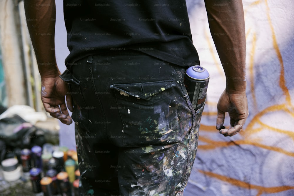 a man is holding a can in his pocket