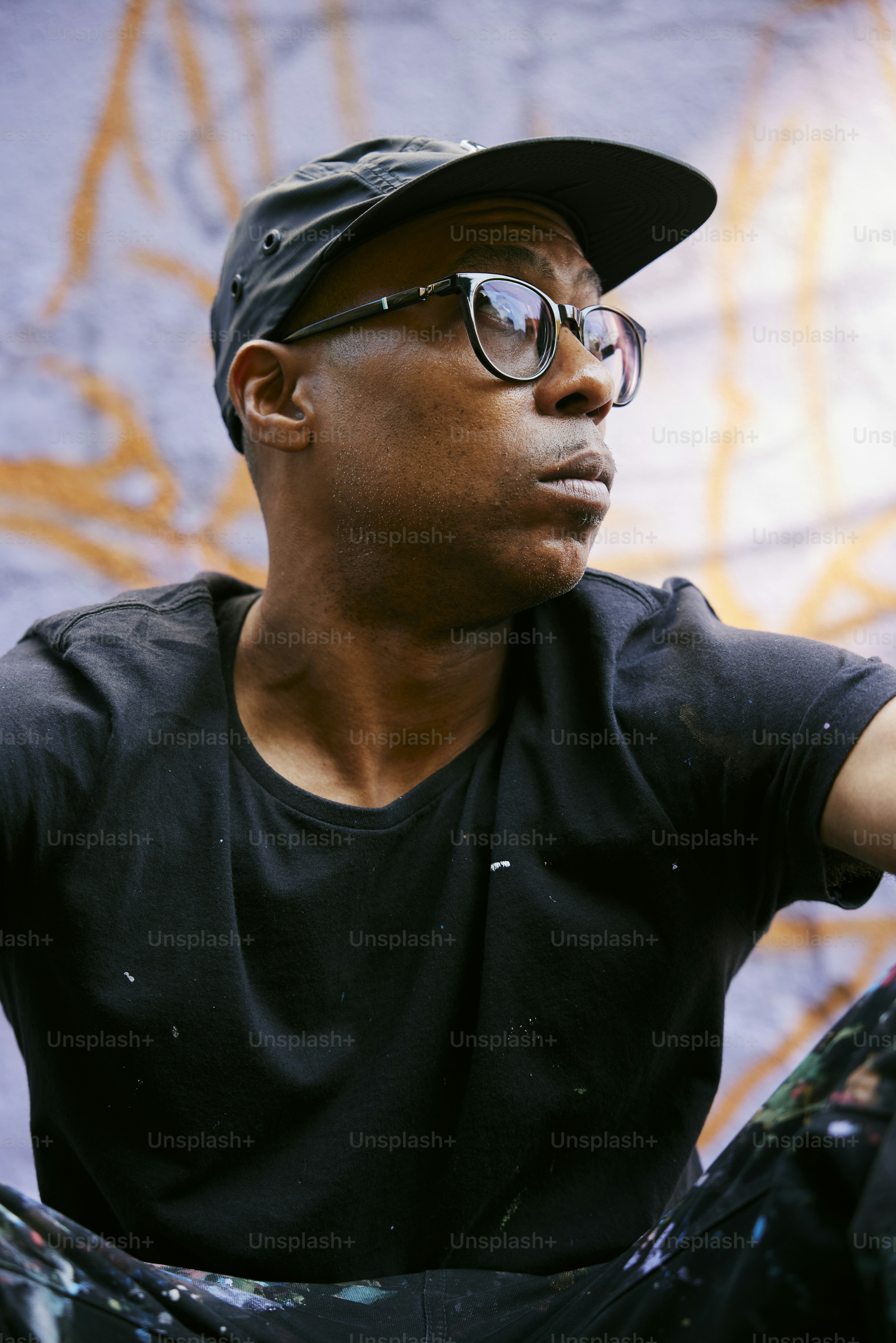 a man in a black shirt and a black hat