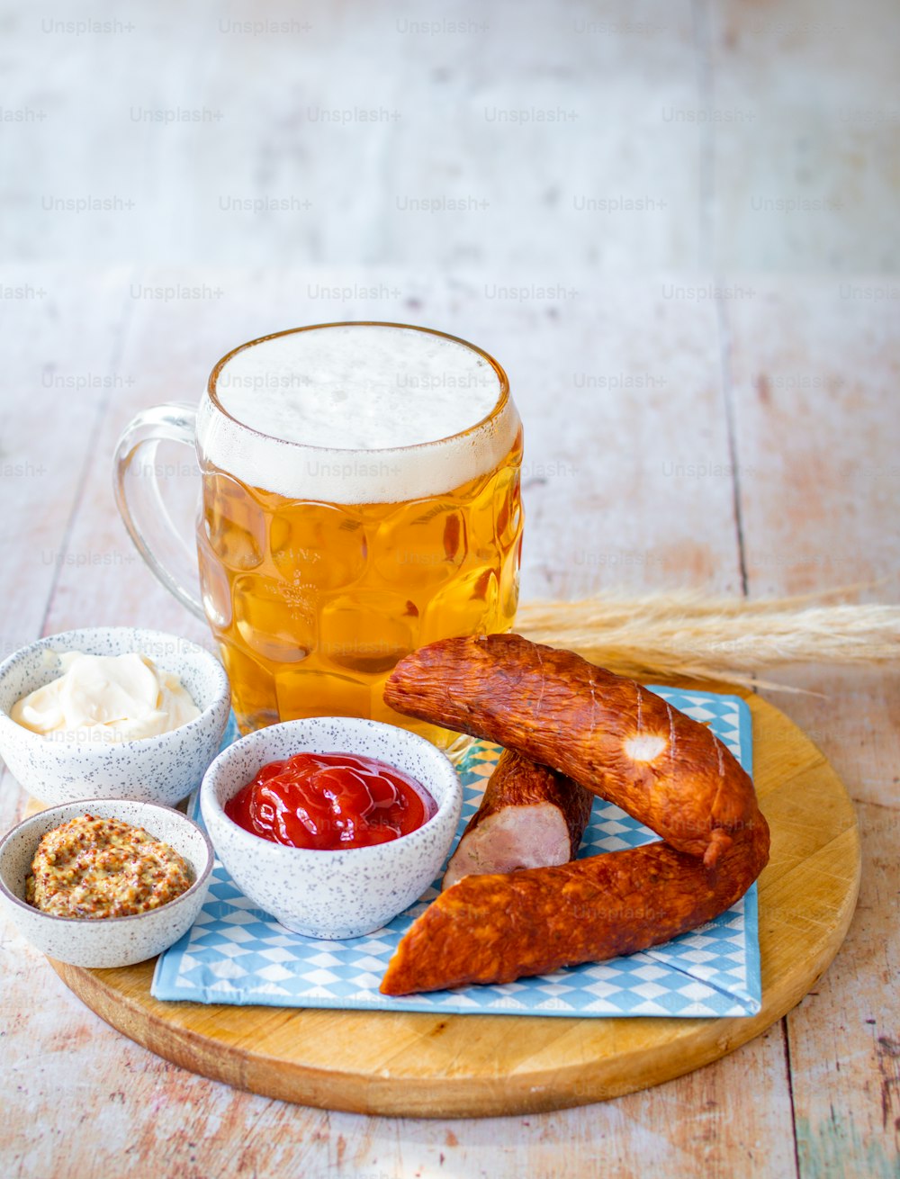 a plate of food and a mug of beer on a table
