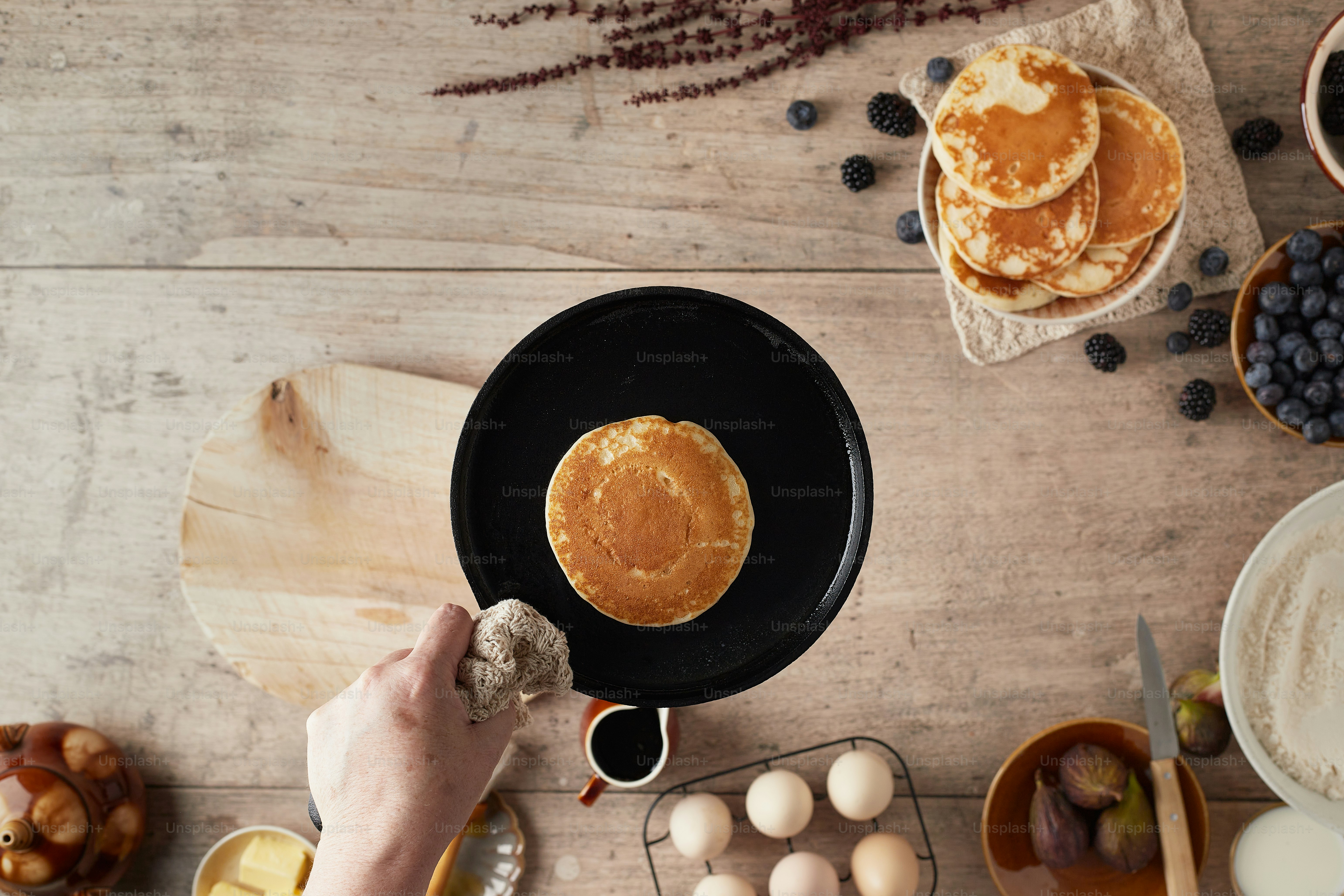 a pancake being prepared on a wooden table