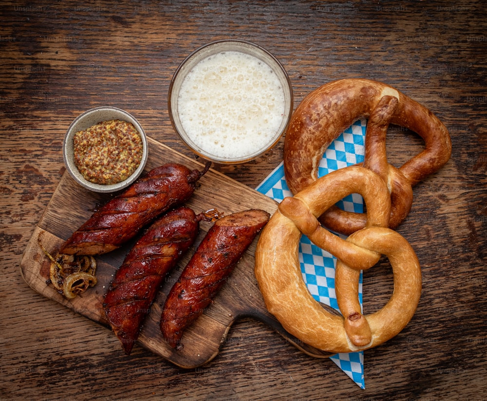 a wooden table topped with pretzels, pretzels and other foods