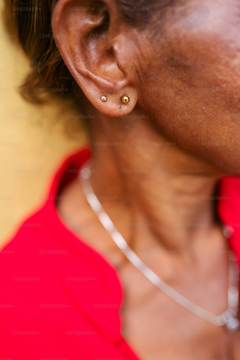 a close up of a person wearing a red shirt