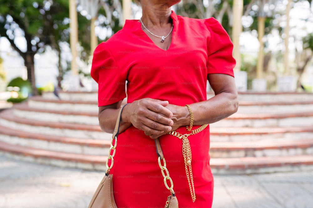 a woman in a red dress holding a purse