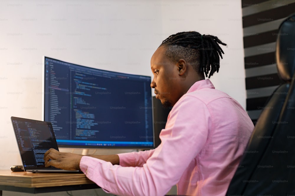 a person sitting at a desk with a laptop