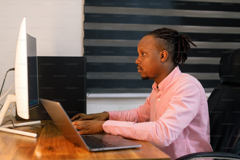 a woman sitting in front of a laptop computer