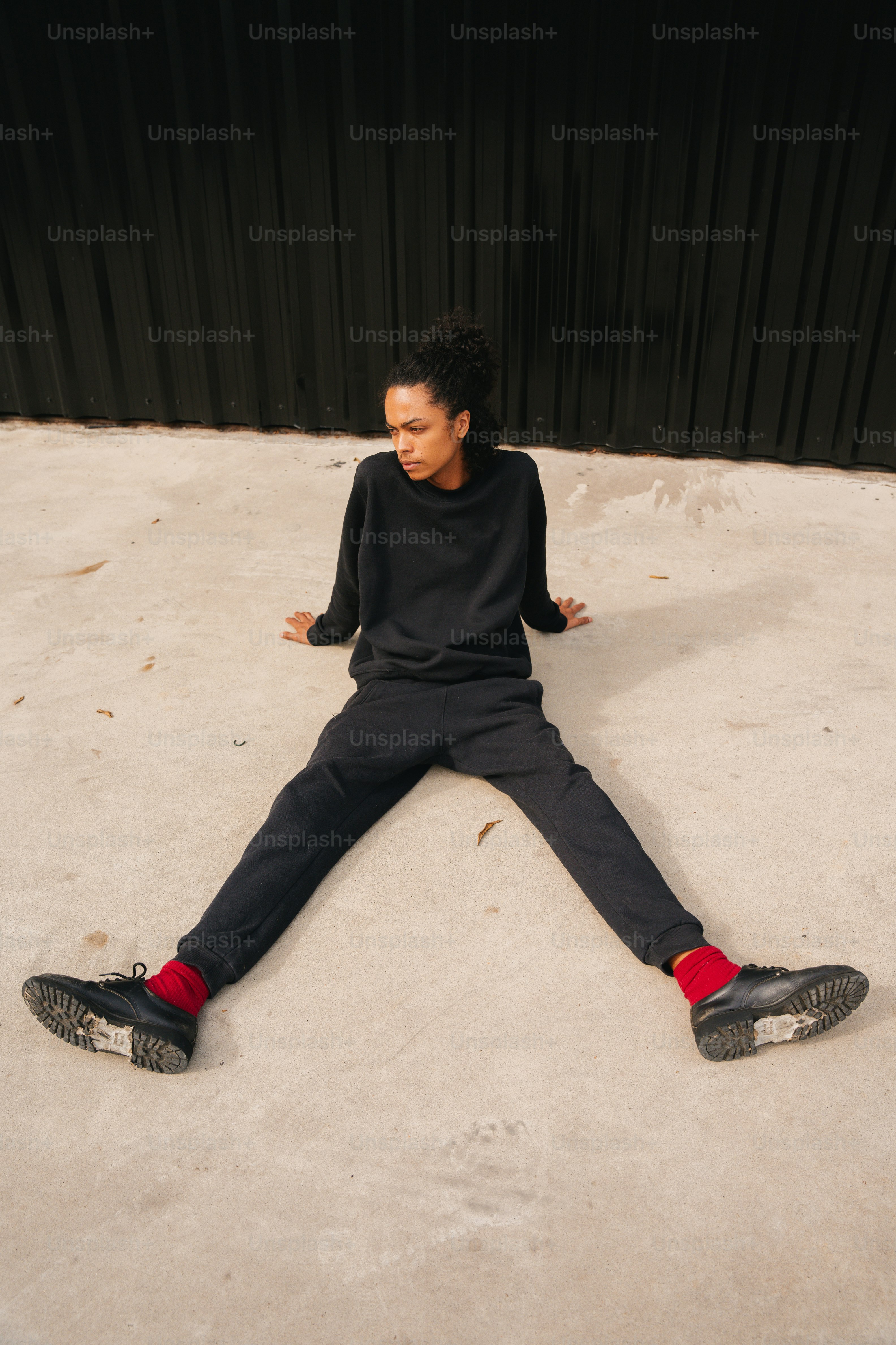 a person sitting on the ground with their legs crossed