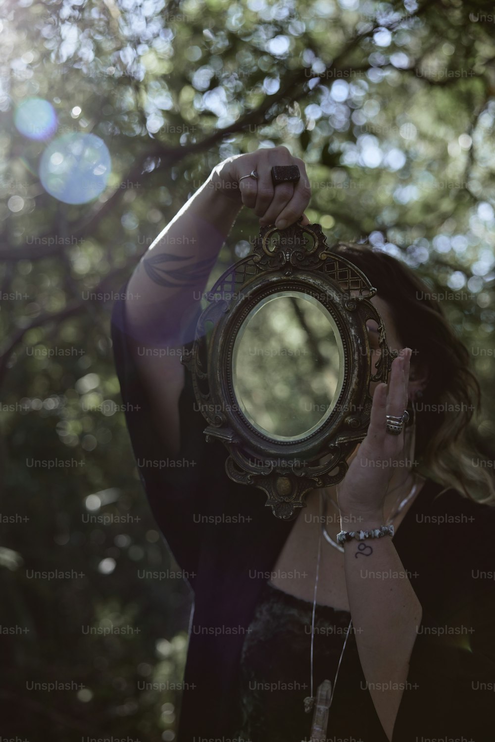 a woman holding a mirror up to her face