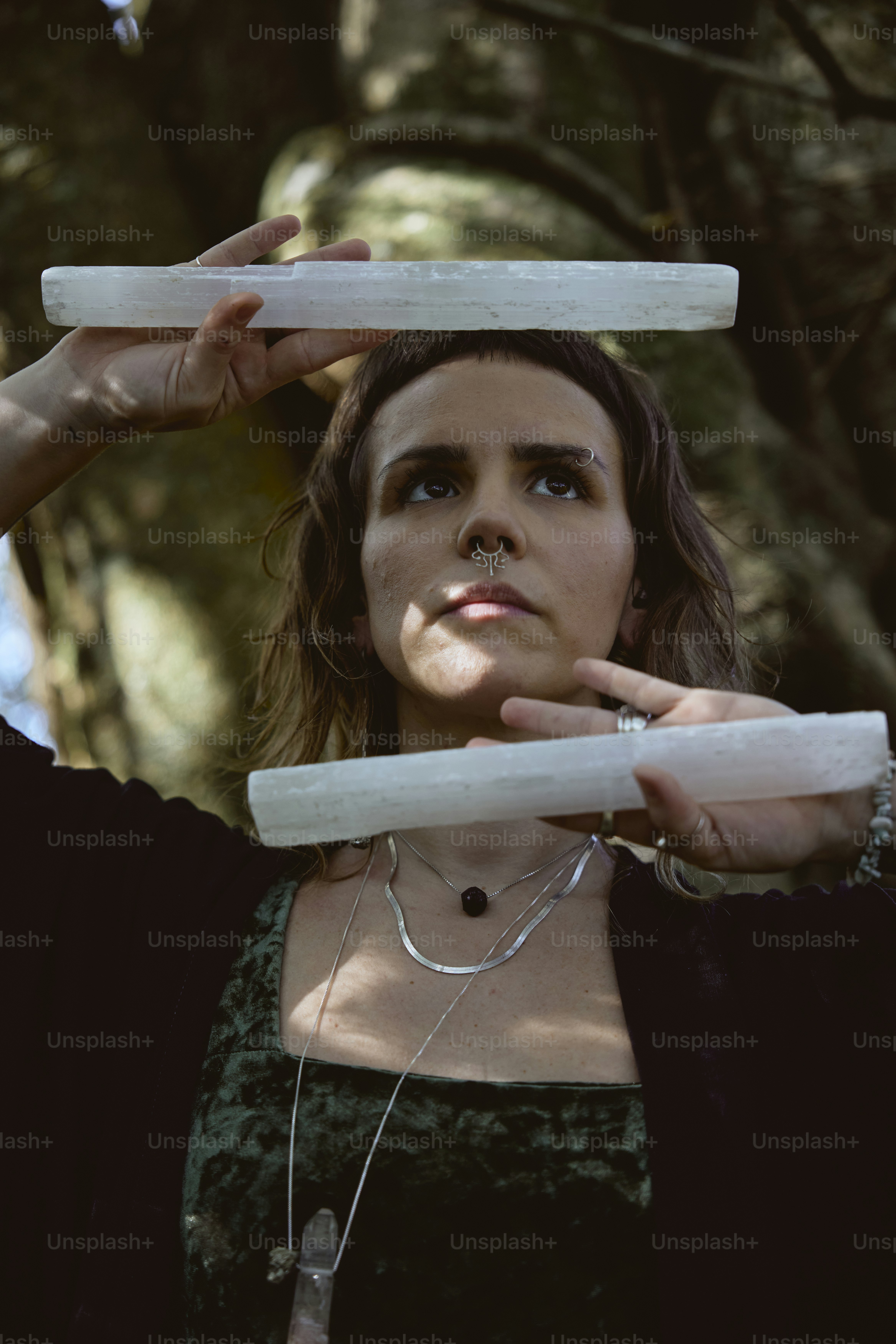 a woman holding two white objects in her hands