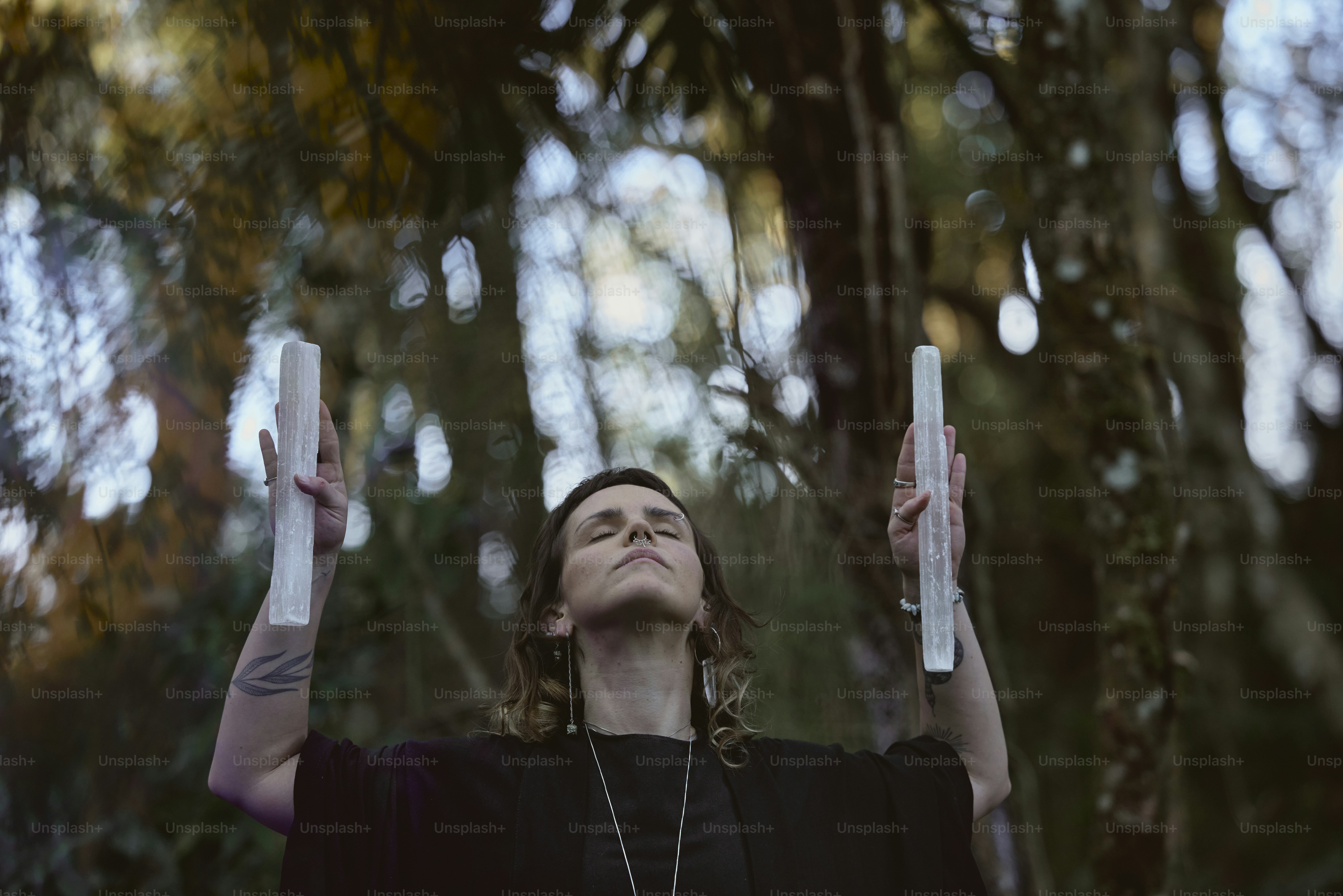a woman holding up two white objects in the air