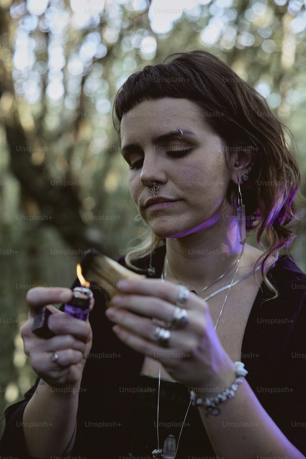 a woman holding a lighter in her hands