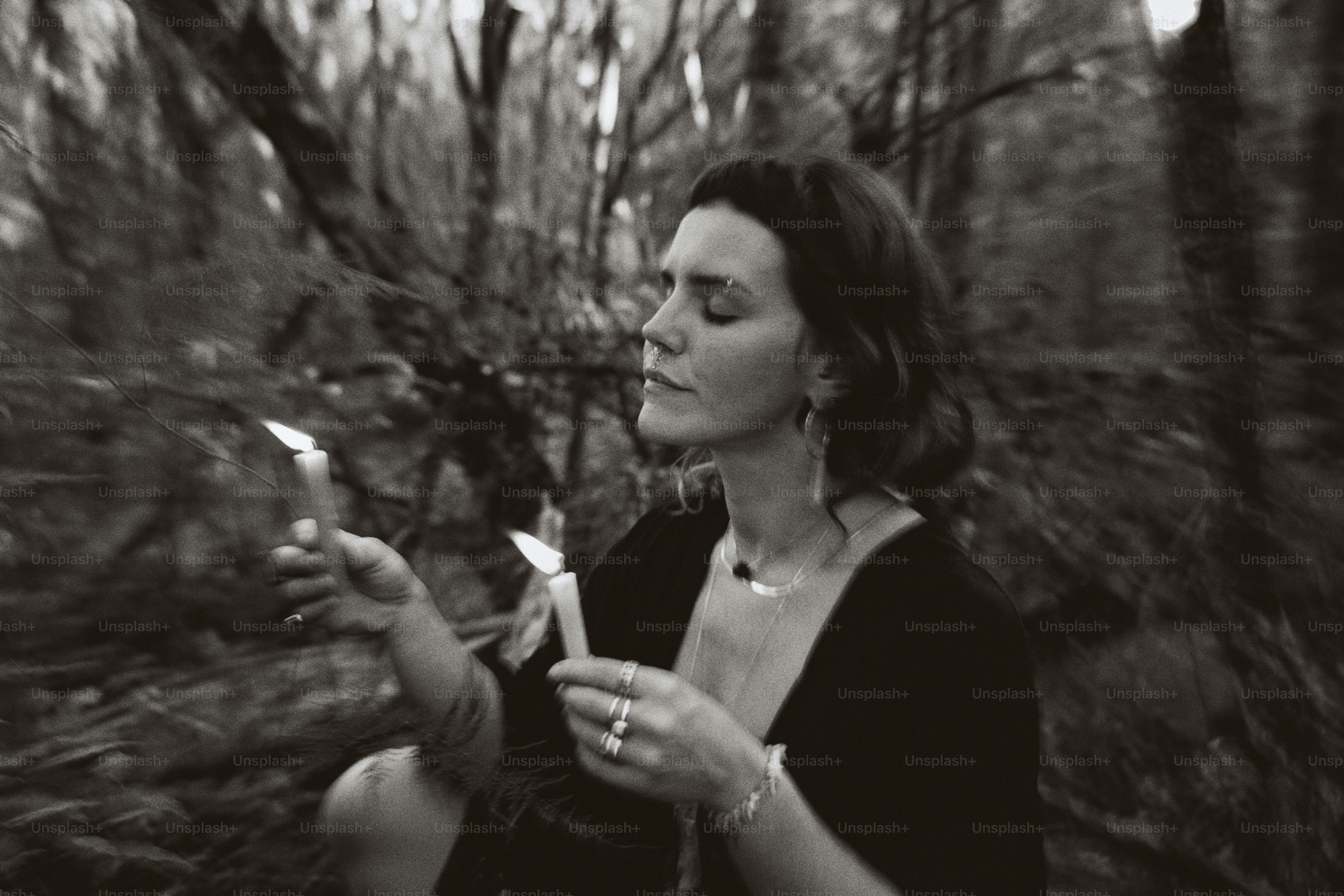 a woman holding two candles in her hands