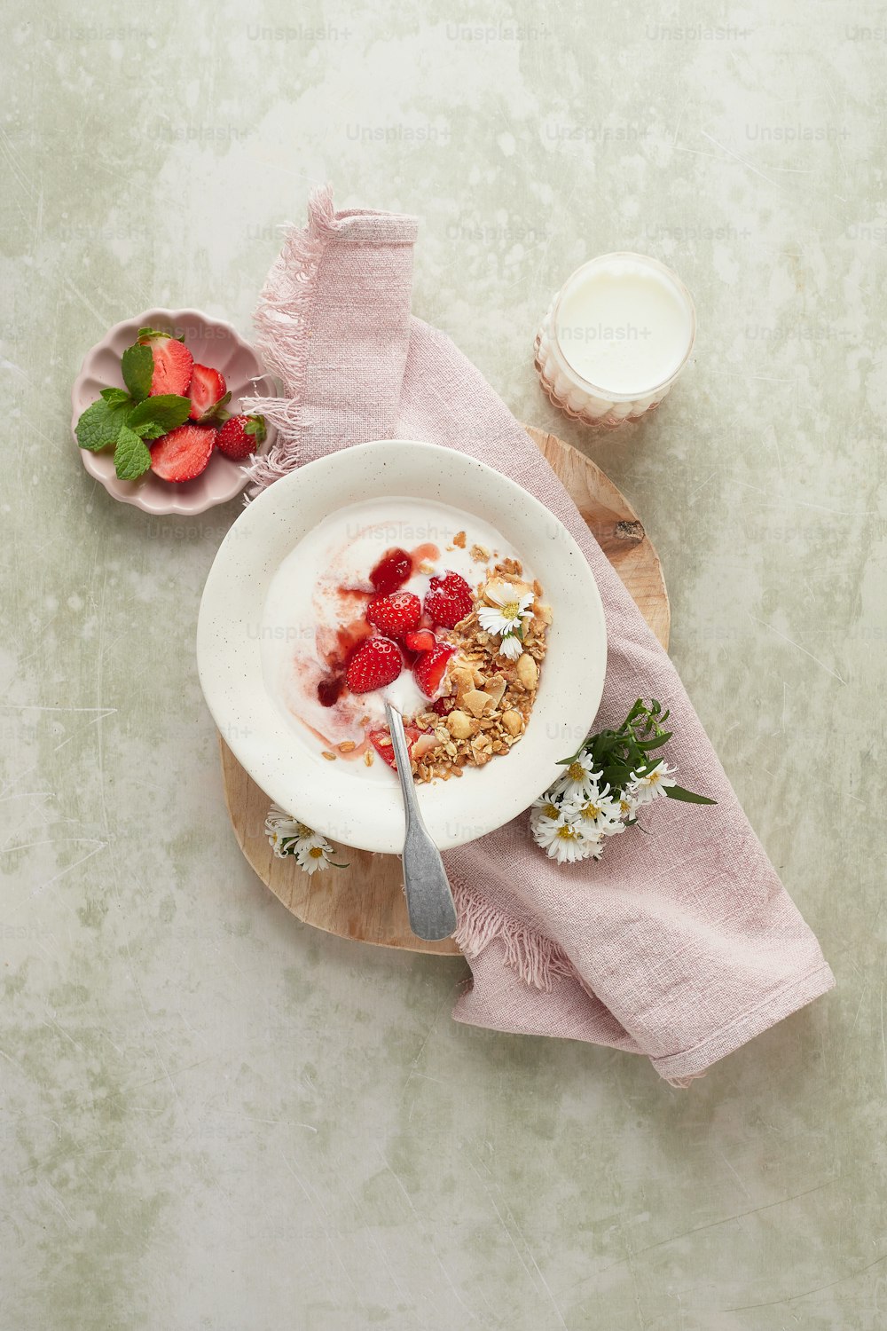 a bowl of cereal with strawberries and yogurt