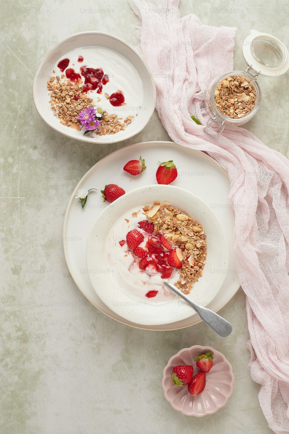 a bowl of granola with strawberries and yogurt