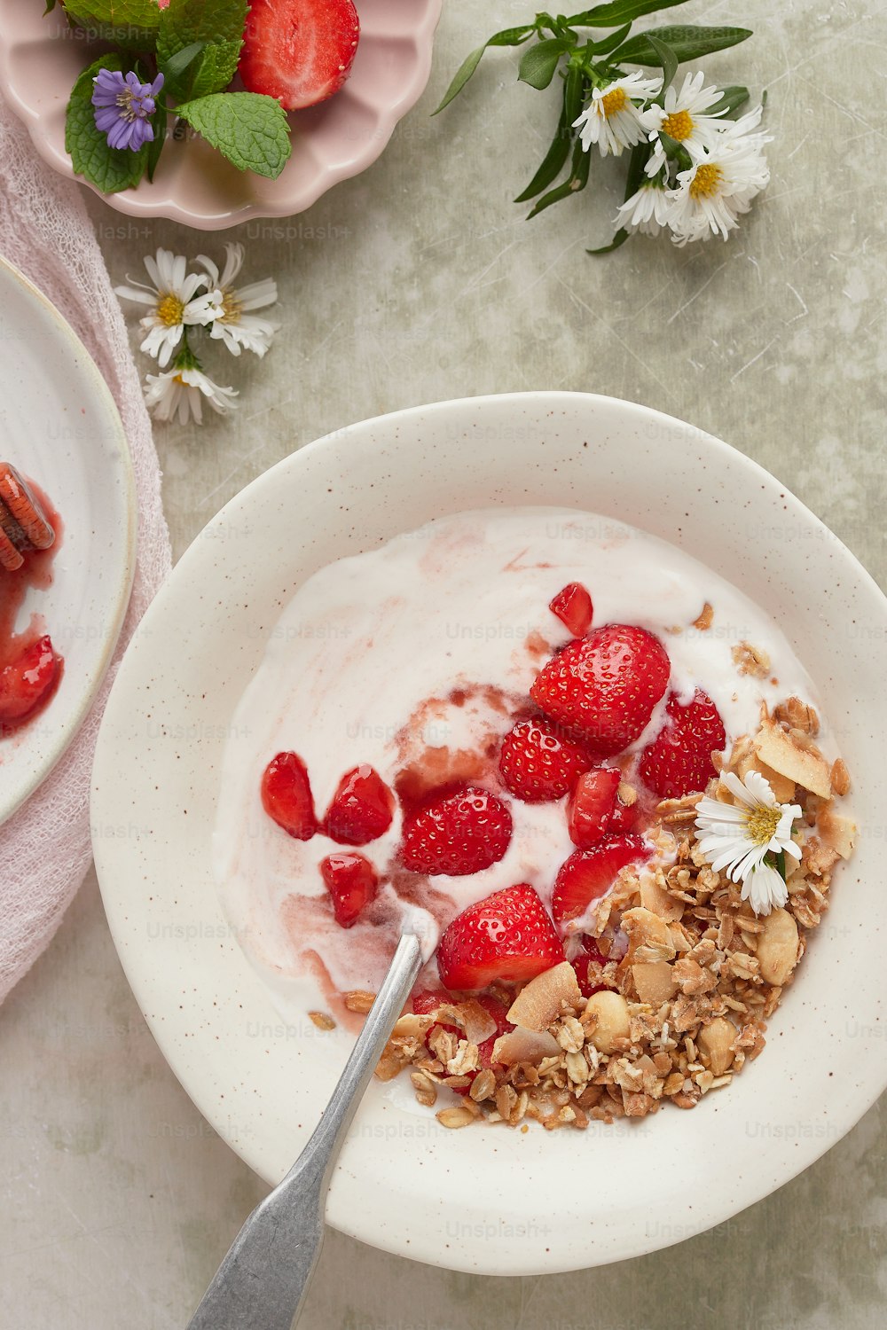 a bowl of yogurt with strawberries and granola