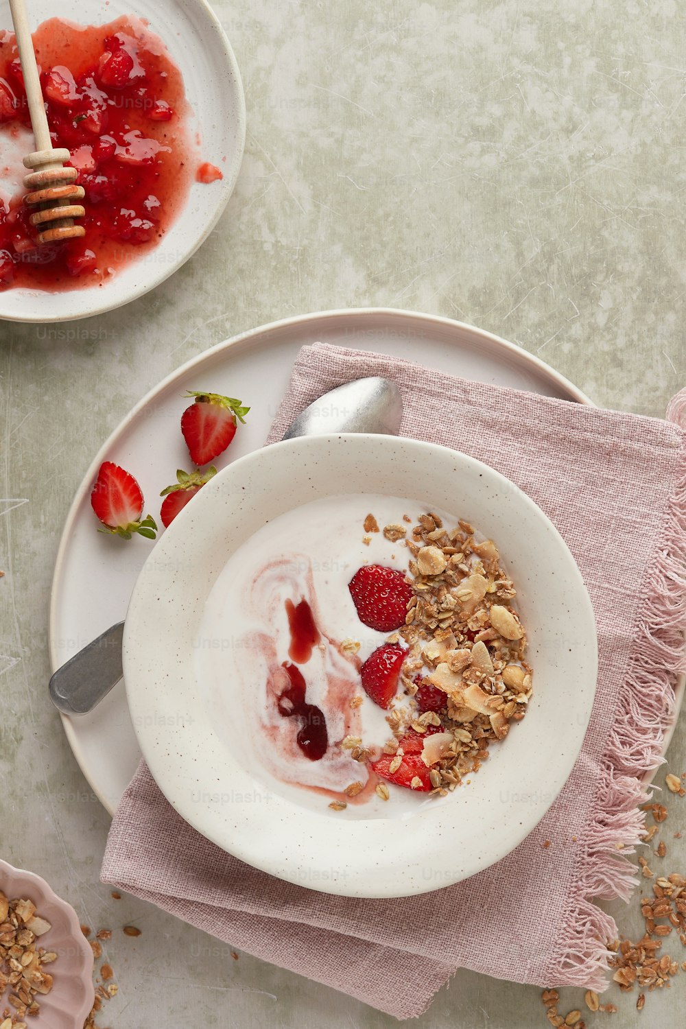 a bowl of yogurt with strawberries and granola