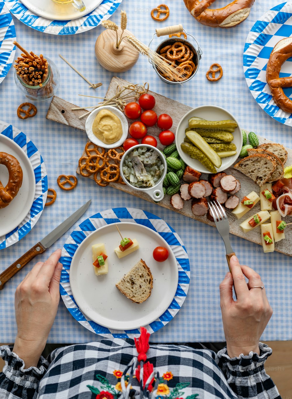 a person sitting at a table with plates of food